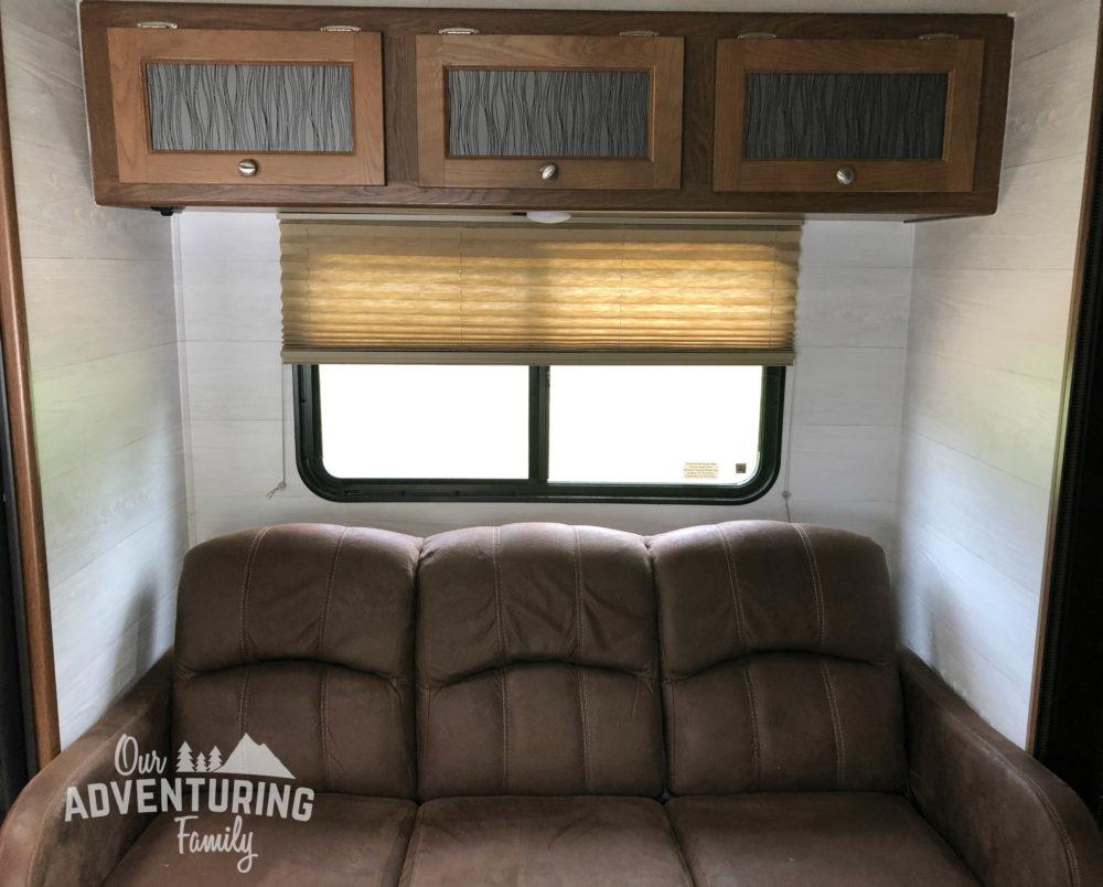 With a little paint and wallpaper we turned our dark cave of an RV into a brighter space. And it cost less than $200! Go too ouradventuringfamily.com to find out how we did it.